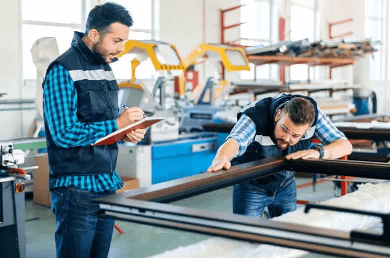 Aluminium fabrication technicians working on custom window frames in an Aussie workshop.